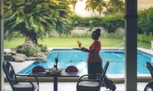 Fiji Gateway Hotel’s team member delivering drinks poolside at Palm Court restaurant.