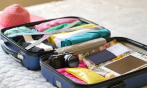 suitcase opened flat with travel items packed inside