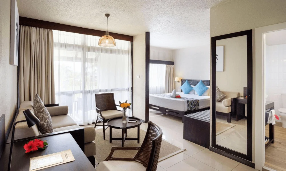 Superior room with lounge area, seating, and king bed at Fiji Gateway Hotel
